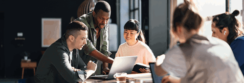 Young professionals or students collaborating in a bright, contemporary co-working environment, displaying teamwork and productivity.