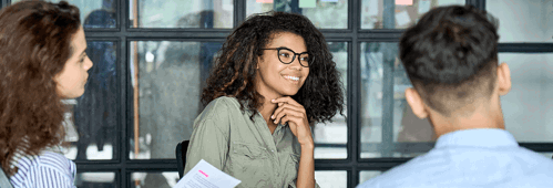 Happy young woman brainstorming marketing ideas